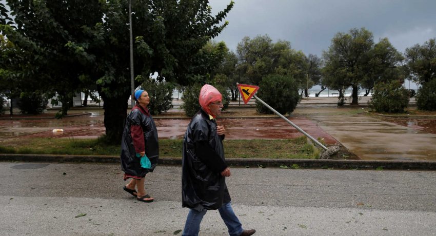 People walk near the town of Amaliada, as a rare storm, known as a Medicane (Mediterranean hurricane), hit western Greece