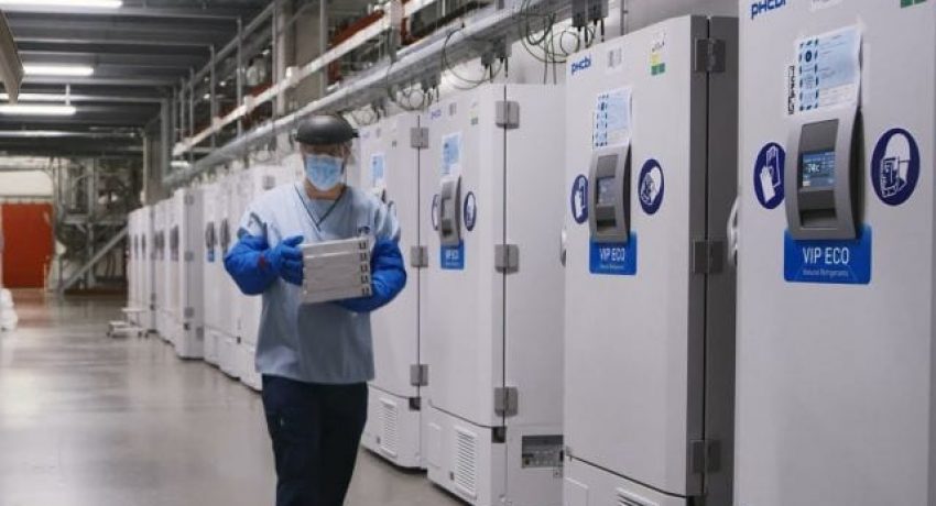 A worker passes a line of freezers holding coronavirus disease (COVID-19) vaccine candidate BNT162b2 at a Pfizer facility in Puurs, Belgium in an undated photograph.   Pfizer/Handout via REUTERS. NO RESALES. NO ARCHIVES. THIS IMAGE HAS BEEN SUPPLIED BY A THIRD PARTY.