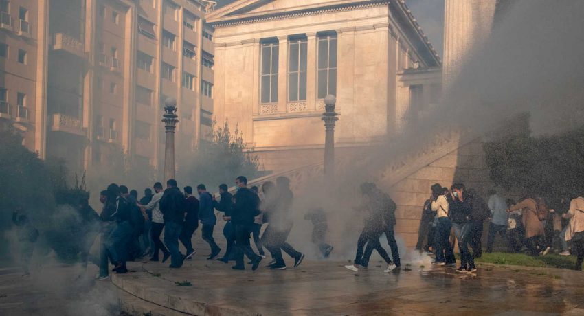 Members of the Greek Communist Party (KKE) flee tear gas and a water cannon during clashes with riot police, as the Greek government banned the annual march to mark the anniversary of a 1973 student revolt against the then military junta due to the coronavirus disease (COVID-19) pandemic, in Athens, Greece, November 17, 2020. REUTERS/Alkis Konstantinidis