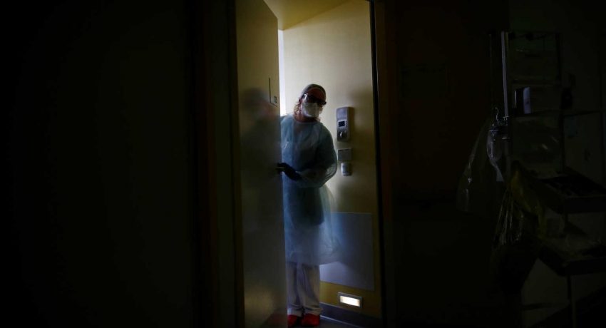 A doctor, wearing a protective mask and a protective suit, works in a pulmonology unit at the hospital in Vannes where patients suffering from the coronavirus disease (COVID-19) are treated, France, October 12, 2020. REUTERS/Stephane Mahe