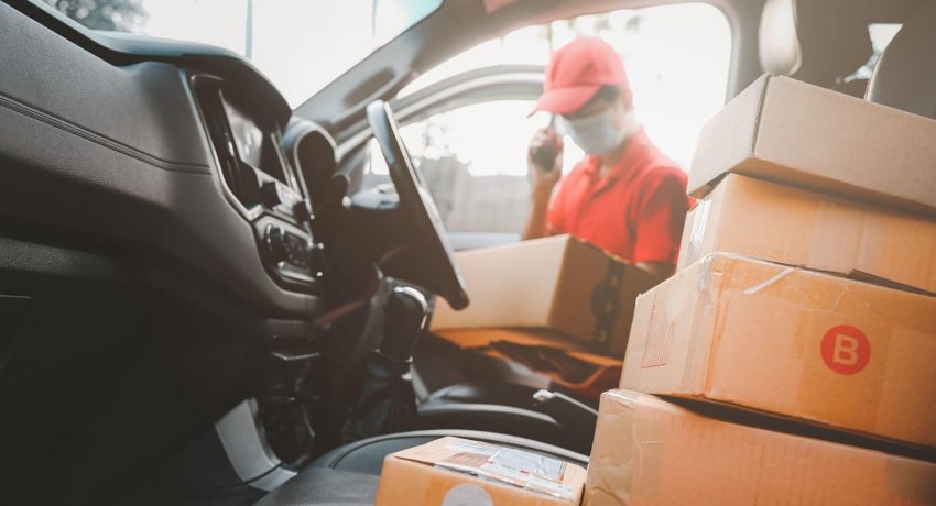 Delivery man call to customers services and wearing medical mask for safety protection from virus infection sender working with postal boxes on delivery car.,Image: 565902686, License: Royalty-free, Restrictions: , Model Release: yes