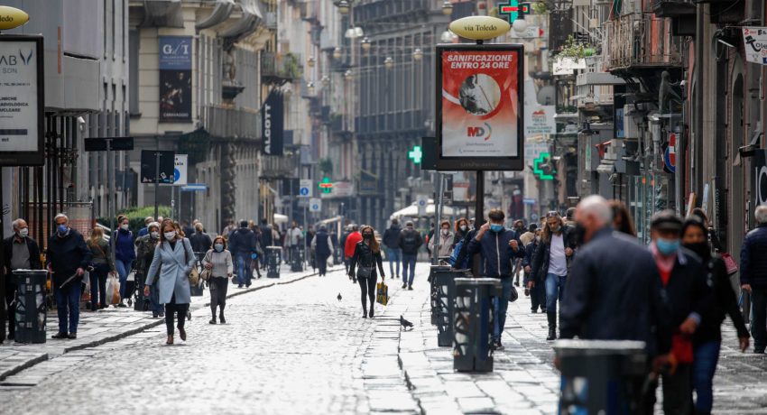 People wearing protective masks walk in the street as the region of Campania becomes a 'red zone', as part of tougher measures to tackle the spread of the coronavirus disease (COVID-19), in Naples, Italy November 16, 2020. REUTERS/Ciro De Luca
