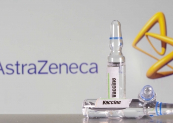 FILE PHOTO: A test tube labeled with the vaccine is seen in front of AstraZeneca logo in this illustration taken, September 9, 2020. REUTERS/Dado Ruvic/File Photo