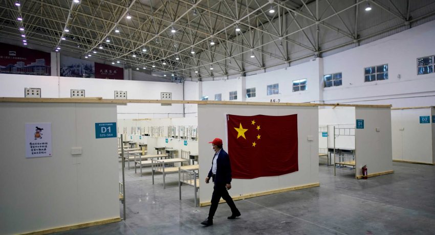 FILE PHOTO: A volunteer walks inside a convention center that was used as a makeshift hospital to treat patients with the coronavirus disease (COVID-19), in Wuhan, Hubei province, China April 9, 2020. REUTERS/Aly Song/File Photo