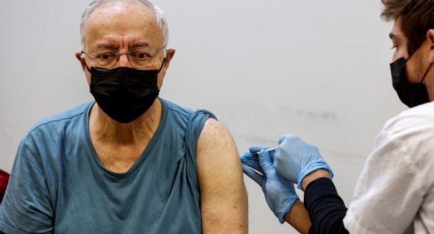 FILE PHOTO: A man receives the fourth dose of the coronavirus disease (COVID-19) vaccine after Israel approved a second booster shot for the immunocompromised, people over 60 years and medical staff, in Tel Aviv, Israel January 3, 2022. REUTERS/Amir Cohen/File Photo