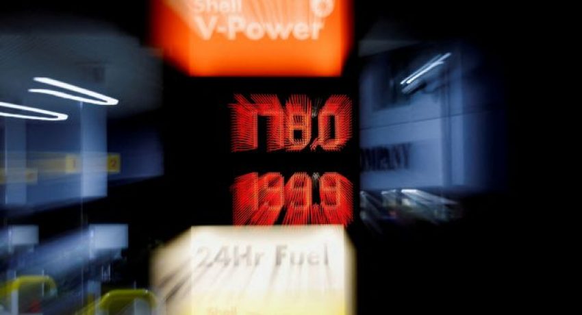 FILE PHOTO: Increased fuel prices are displayed at a filling station in Long Stratton, Britain, March 10, 2022. Picture taken with a zoom burst exposure. REUTERS/Andrew Boyers/File Photo