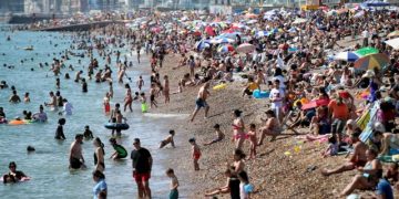 People enjoy the sunny weather at the Brighton Beach, amid the coronavirus disease (COVID-19) outbreak, in Brighton, Britain, August 7, 2020. REUTERS/Peter Cziborra