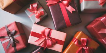 Stylishly packaged boxes with gifts closeup.