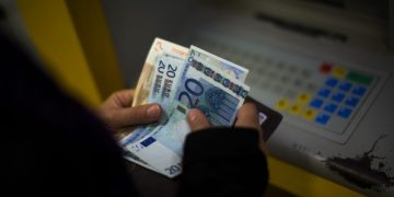 A woman holds euros bills after withdrawing her money from a cash machine in Barcelona, Spain, Wednesday Jan. 23, 2013. Spain's recession deepened in the fourth quarter of 2012, when the economy shrank by 0.6 percent compared with the previous three-month period, according to preliminary estimates from the Bank of Spain on Wednesday. (AP Photo/Emilio Morenatti)