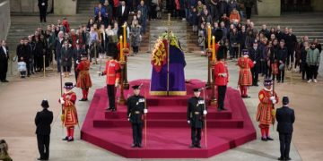 FILE PHOTO: At 06:02am on the day of her funeral the final members of the public pay their respects at the coffin of Queen Elizabeth II, draped in the Royal Standard with the Imperial State Crown and the Sovereign's orb and sceptre, lying in state on the catafalque in Westminster Hall, at the Palace of Westminster, London. Picture date: Monday September 19, 2022.   Yui Mok/Pool via REUTERS/File Photo