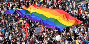 People march with their giant rainbow flag from the parliament building in Budapest downtown during the lesbian, gay, bisexual and transgender (LGBT) Pride Parade in the Hungarian capital on July 6, 2019. (Photo by ATTILA KISBENEDEK / AFP)
