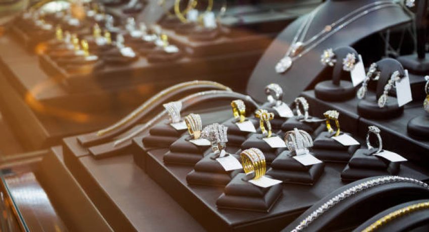 Gold jewelry diamond shop with rings and necklaces luxury retail store window display showcase